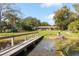 Wooden walkway leads to a small boat on the lake at 4135 Chuluota Rd, Orlando, FL 32820