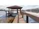 Wooden dock with covered seating area overlooking lake at 4135 Chuluota Rd, Orlando, FL 32820