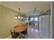 Eat-in kitchen with gray cabinets, wood table, and white appliances at 4135 Chuluota Rd, Orlando, FL 32820