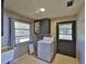 Laundry room with utility sink and exterior door at 4135 Chuluota Rd, Orlando, FL 32820