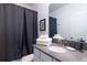 Simple bathroom with gray countertops and dark gray shower curtain at 4152 Paragraph Dr, Kissimmee, FL 34746