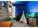 bedroom with bunk beds, teepee, and starry night wall decor at 4152 Paragraph Dr, Kissimmee, FL 34746