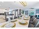 Elegant dining room with a long white table and gray chairs at 4152 Paragraph Dr, Kissimmee, FL 34746