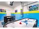 Game room with air hockey table and fun decor at 4152 Paragraph Dr, Kissimmee, FL 34746