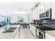 Modern kitchen with white cabinets and stainless steel appliances at 4152 Paragraph Dr, Kissimmee, FL 34746