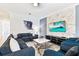Spacious living room with sectional sofa and large TV at 4152 Paragraph Dr, Kissimmee, FL 34746