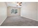 Spacious bedroom with neutral carpeting and large window at 4876 Conway Rd # 96, Orlando, FL 32812