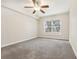 Spacious bedroom with neutral carpeting and large window at 4876 Conway Rd # 96, Orlando, FL 32812