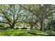 Lush courtyard with mature trees and seating areas at 4876 Conway Rd # 96, Orlando, FL 32812