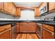 Modern kitchen with stainless steel appliances and wood cabinets at 4876 Conway Rd # 96, Orlando, FL 32812