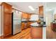 Modern kitchen with stainless steel appliances and wood cabinets at 4876 Conway Rd # 96, Orlando, FL 32812