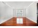 Spacious living room featuring hardwood floors and a large window at 4876 Conway Rd # 96, Orlando, FL 32812