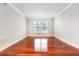 Living room with hardwood floors and a large window at 4876 Conway Rd # 96, Orlando, FL 32812