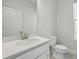 A bathroom featuring a white vanity, white quartz countertops, and modern fixtures at 520 Orient Ave, Debary, FL 32713