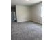 Spacious bedroom with neutral carpet, walls, and a bright window at 520 Orient Ave, Debary, FL 32713