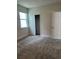 Cozy bedroom featuring soft gray carpet, natural lighting, and a closet at 520 Orient Ave, Debary, FL 32713