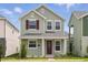 Charming two-story home featuring light green siding, red shutters, and a welcoming front porch at 520 Orient Ave, Debary, FL 32713