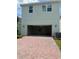 Two-story home with a spacious garage and a charming brick driveway for ample parking at 520 Orient Ave, Debary, FL 32713