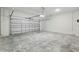 Spacious garage with a large door and concrete floor at 520 Orient Ave, Debary, FL 32713