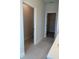 Hallway showing access to a bathroom and walk-in closet at 520 Orient Ave, Debary, FL 32713
