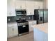 Well-lit kitchen featuring modern appliances, sleek cabinets, and a stylish backsplash at 520 Orient Ave, Debary, FL 32713