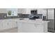 A kitchen featuring white cabinetry, stainless appliances and a center island at 520 Orient Ave, Debary, FL 32713