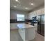 Bright kitchen with stainless steel appliances, white cabinetry, and a large island at 520 Orient Ave, Debary, FL 32713