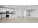 Open-concept living area featuring modern lighting, sleek tile flooring and flowing to the kitchen at 520 Orient Ave, Debary, FL 32713
