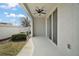 Covered patio with ceiling fan and access to the backyard at 5427 Dragonfly Dr, Wildwood, FL 34785