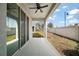 Covered patio with ceiling fan, overlooking a fenced backyard at 5427 Dragonfly Dr, Wildwood, FL 34785