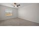 Well-lit bedroom featuring a ceiling fan and carpet at 5427 Dragonfly Dr, Wildwood, FL 34785
