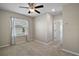 Bright bedroom with ceiling fan and carpeted floor at 5427 Dragonfly Dr, Wildwood, FL 34785