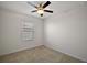 Bright bedroom with carpet flooring and a ceiling fan at 5427 Dragonfly Dr, Wildwood, FL 34785