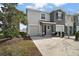 Modern two-story house with gray exterior, two-car garage, and landscaped front yard at 5427 Dragonfly Dr, Wildwood, FL 34785