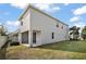 House exterior with covered patio and yard at 5427 Dragonfly Dr, Wildwood, FL 34785