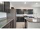 Modern kitchen with dark cabinets and granite countertops at 5427 Dragonfly Dr, Wildwood, FL 34785