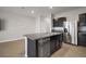Modern kitchen with dark cabinets, granite counters, and stainless steel appliances at 5427 Dragonfly Dr, Wildwood, FL 34785