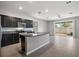 Modern kitchen with island, stainless steel appliances, and granite countertops at 5427 Dragonfly Dr, Wildwood, FL 34785