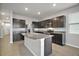 Modern kitchen with dark cabinets, granite countertops, and stainless steel appliances at 5427 Dragonfly Dr, Wildwood, FL 34785
