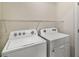 Laundry room with Whirlpool washer and dryer at 5427 Dragonfly Dr, Wildwood, FL 34785