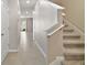 Modern staircase with carpeted steps and tile flooring at 5427 Dragonfly Dr, Wildwood, FL 34785