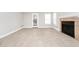 Bright living room featuring tile floors, fireplace, and sliding glass door to patio at 5600 Devonbriar Way # 204, Orlando, FL 32822