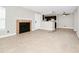 Open concept living room with tile floors, fireplace, and kitchen bar at 5600 Devonbriar Way # 204, Orlando, FL 32822