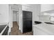 Kitchen with stainless steel fridge and wood-look floors at 670 Sandy Neck Ln # 103, Altamonte Springs, FL 32714