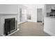 Living room with fireplace, wood-look floors and large windows at 670 Sandy Neck Ln # 103, Altamonte Springs, FL 32714