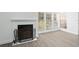 Bright living room with fireplace and wood-look floors at 670 Sandy Neck Ln # 103, Altamonte Springs, FL 32714