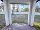 View of backyard through covered patio; fenced yard with trees at 849 Rivers Crossing St, Clermont, FL 34714