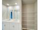 Double vanity bathroom with a walk-in shower and wire shelving at 849 Rivers Crossing St, Clermont, FL 34714
