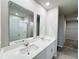 Double vanity bathroom with a walk-in shower and linen closet at 849 Rivers Crossing St, Clermont, FL 34714