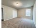 Spacious carpeted bedroom with double doors and window at 849 Rivers Crossing St, Clermont, FL 34714